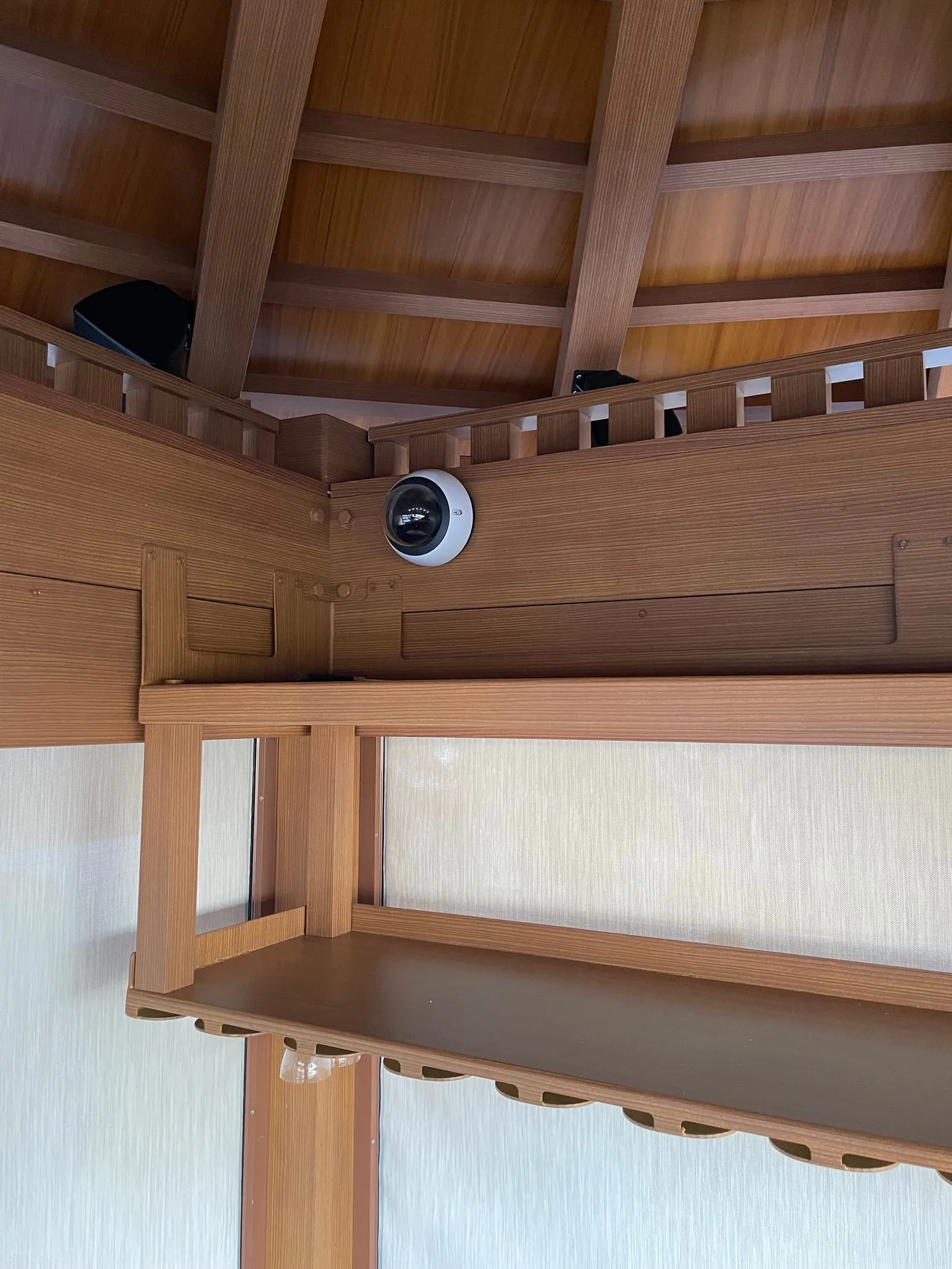 Verkada dome camera mounted in the Hotel Del Coronado bar pavilion exposed-beam ceiling