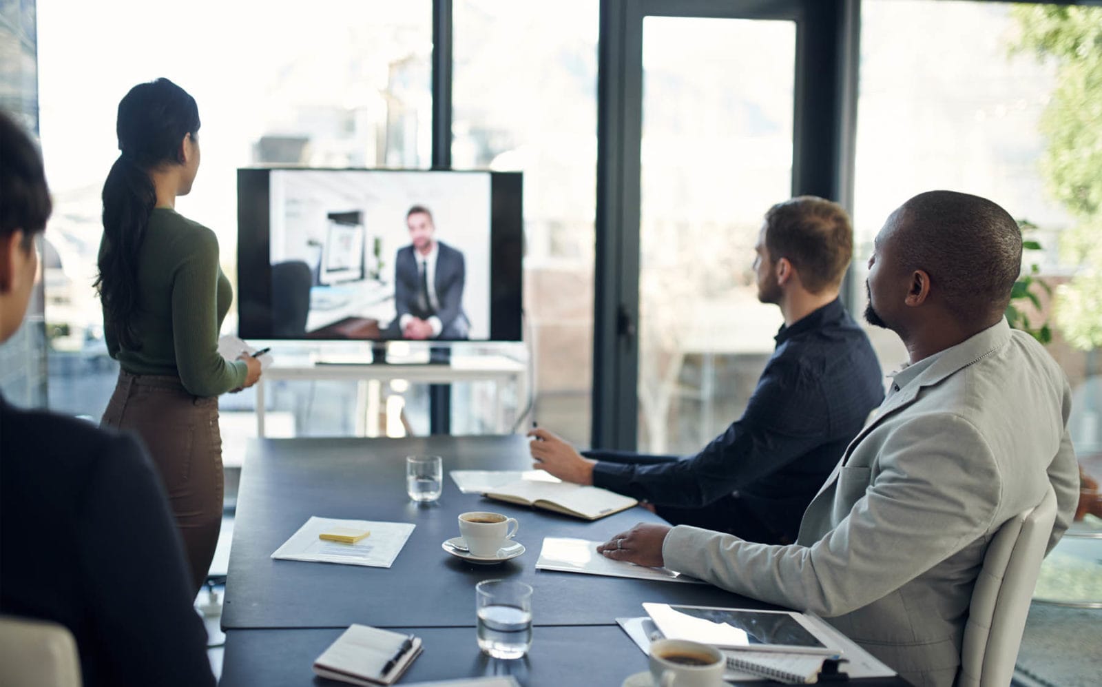 Business meeting with video conference participant